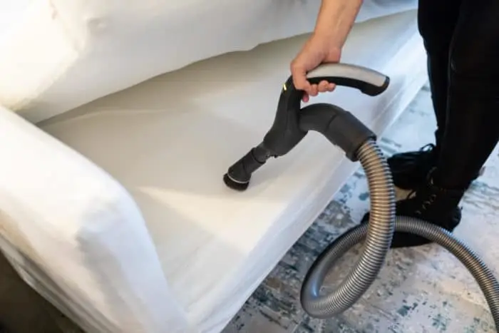 Person vacuuming couch